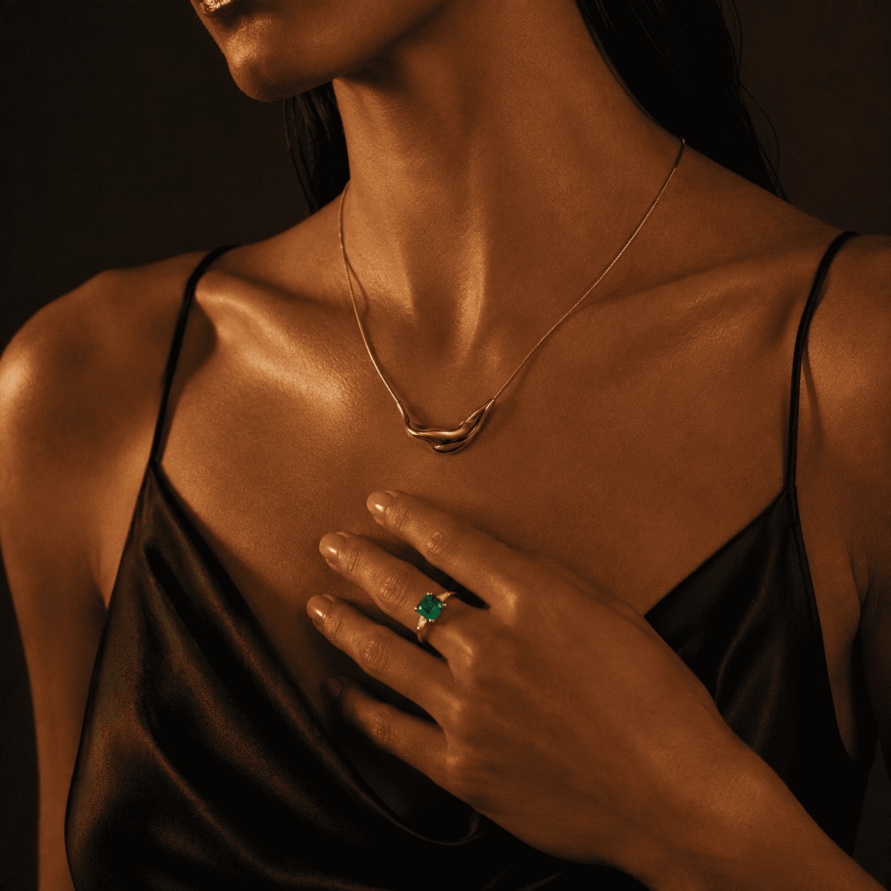 An ALARÉ necklace and ring worn